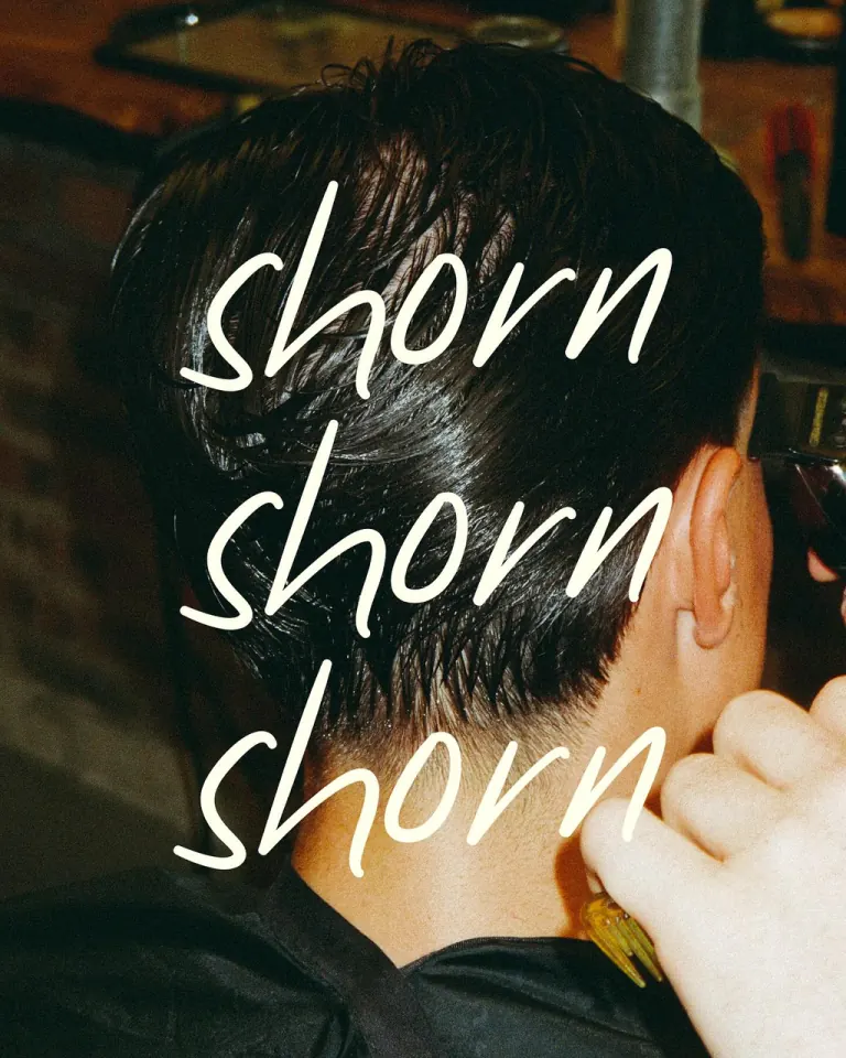The back of a freshly cut head with the word shorn handwritten across the photo