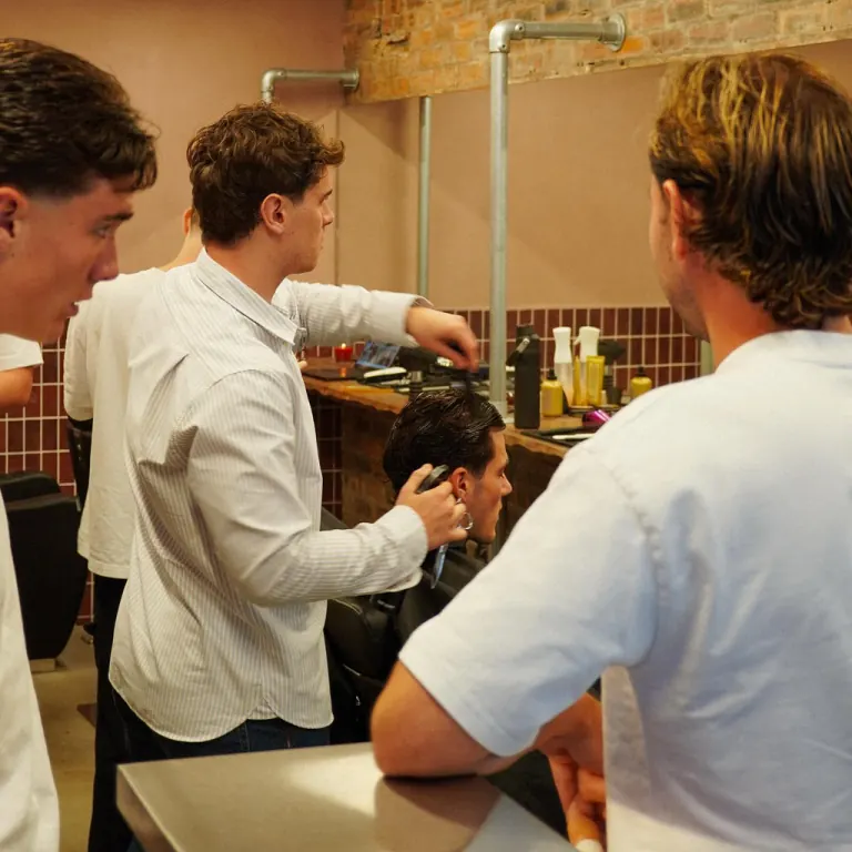 Stylists at work inside the brick-walled Shorn salon